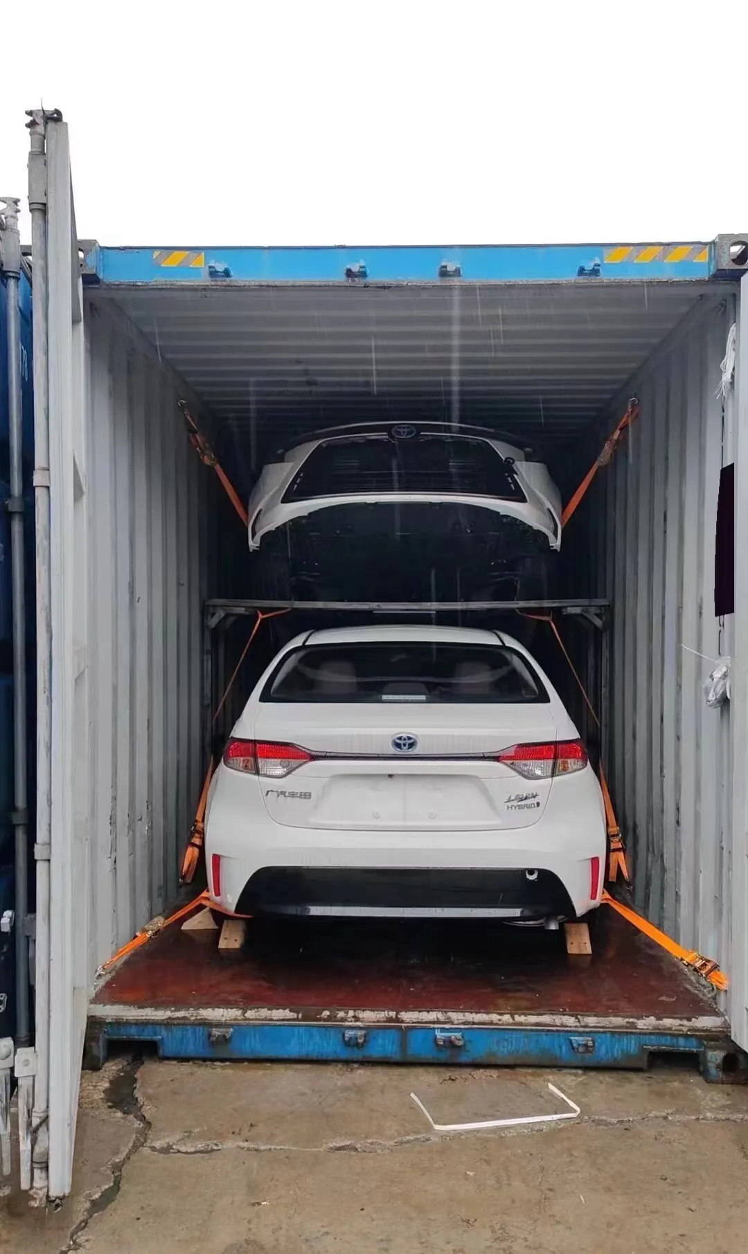 Sedan loaded and strapped inside a container